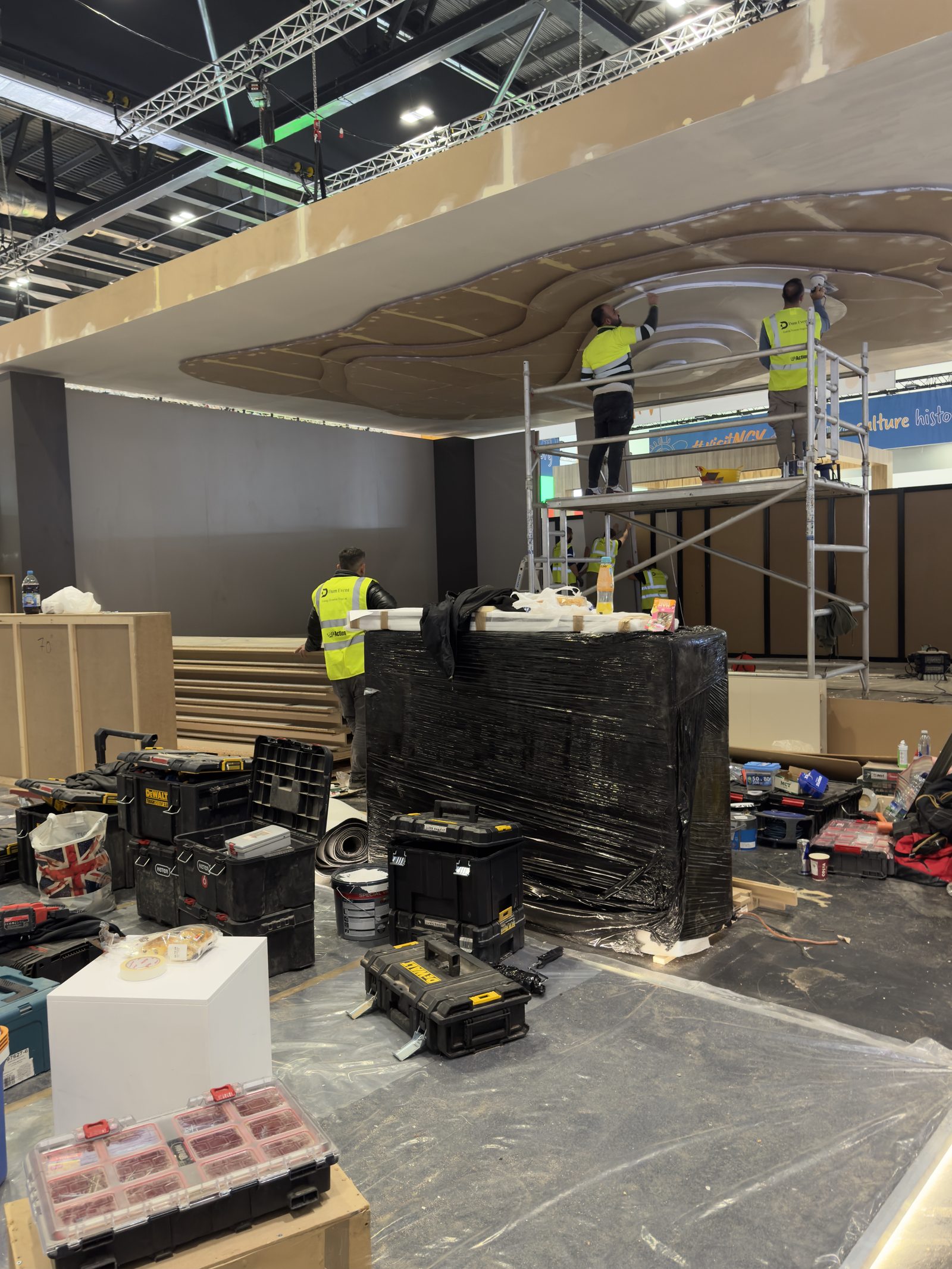 Dum Event build crew installing a sculpted ceiling feature on site