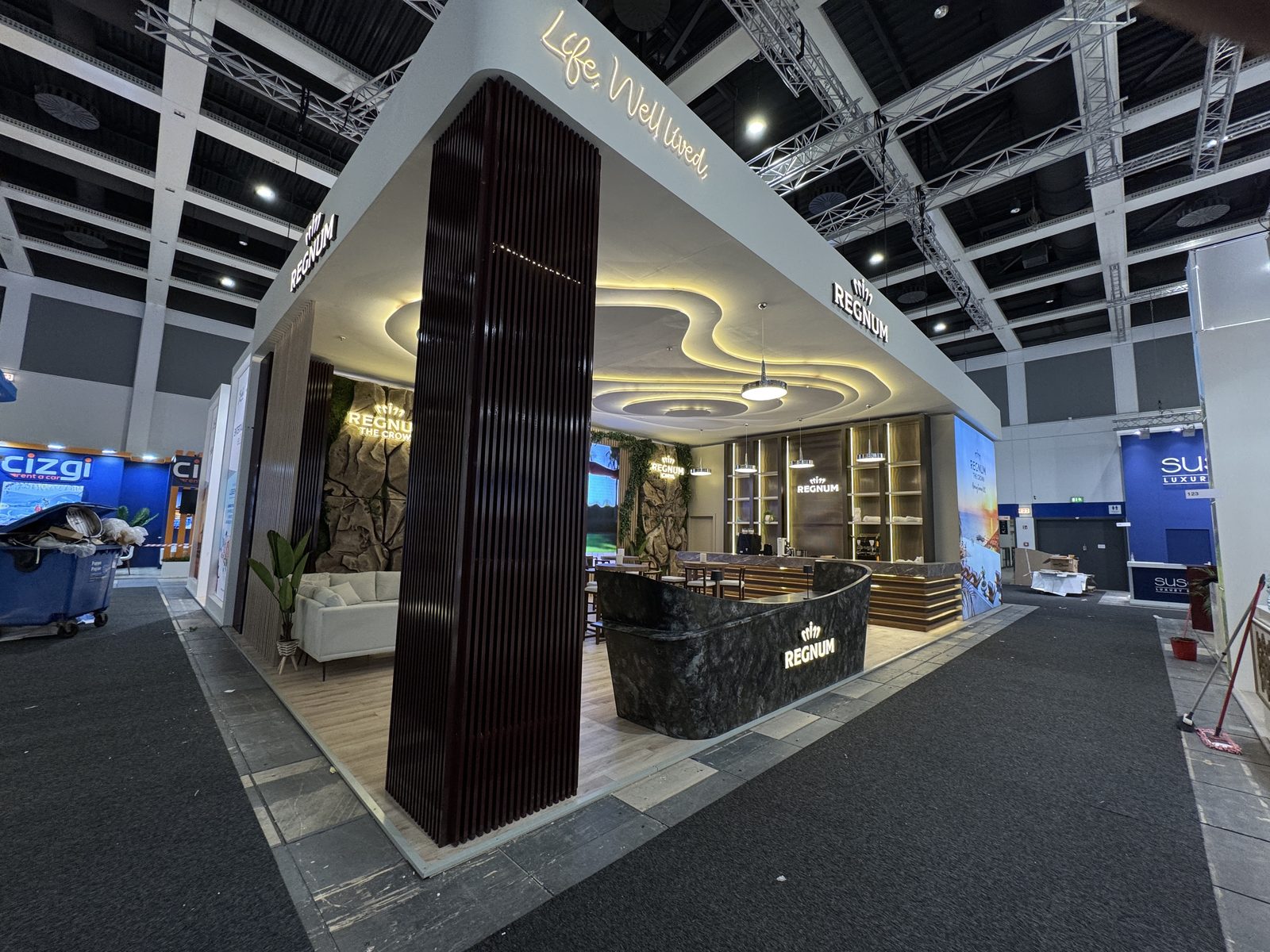 Bespoke exhibition stand with custom wooden construction and shaped ceiling